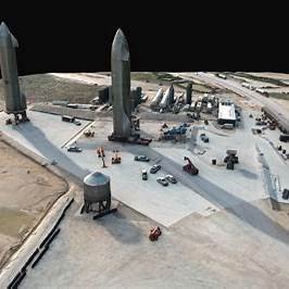 Spacecraft launch site with rockets and facilities.